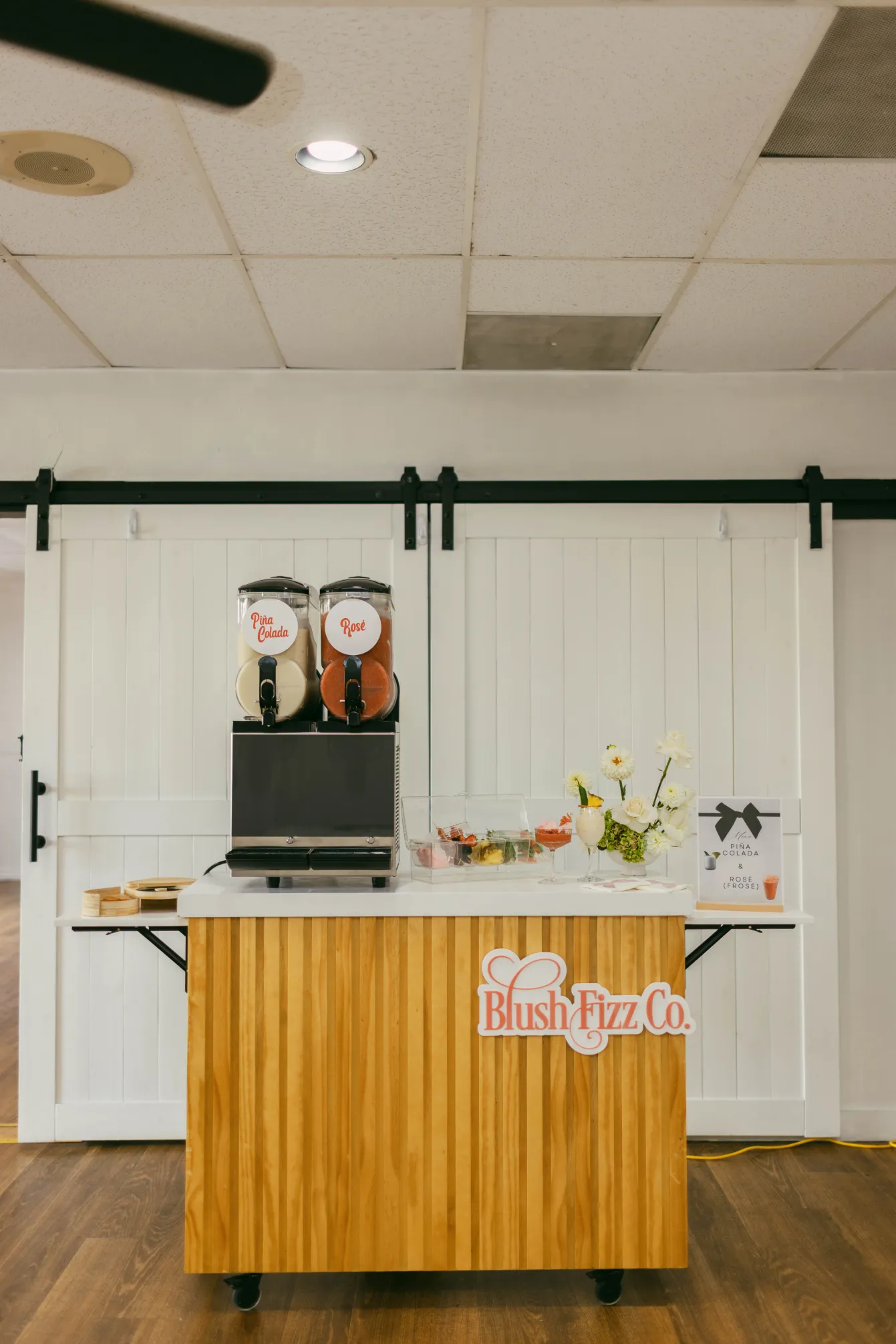 Blush Fizz Co. frozen drink cart fully set up at an event venue